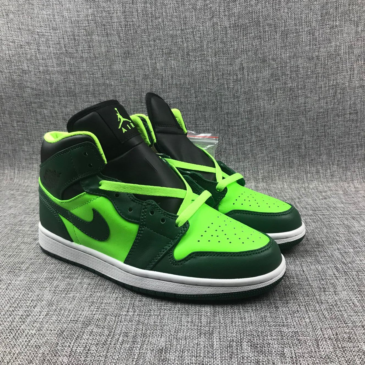 Air Jordan 1 Mid Fluorescent Sneakers in Green 554724-330 - product image from the listing.