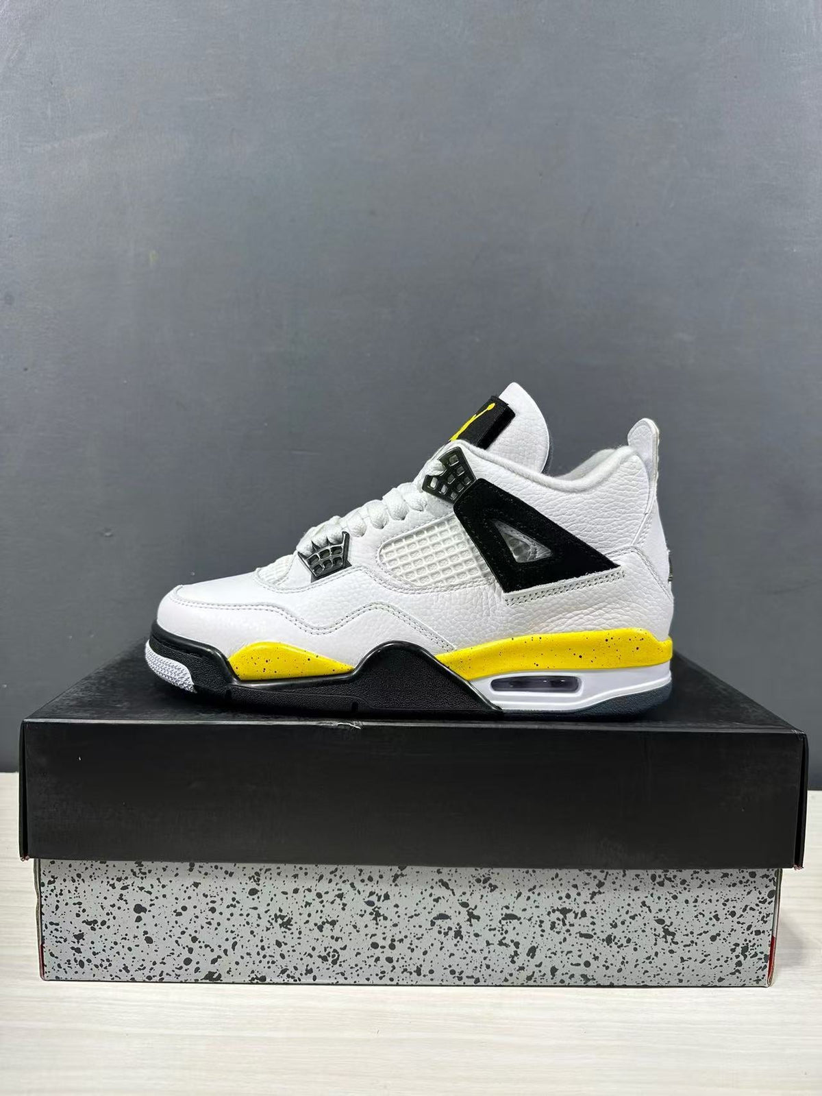 Air Jordan 4 Retro White Yellow Black Sneakers IO2468-102 - product image from the listing.