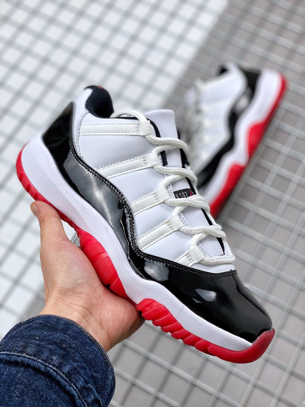 Air Jordan 11 Win Like '82 Sneakers in White Black Red - product image from the listing.