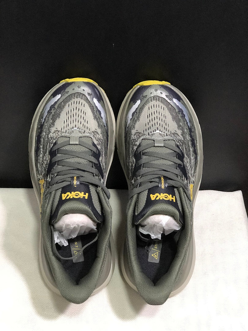 HOKA Stinson 7 Trail Running Shoes, in Gray and Yellow - product image from the listing.