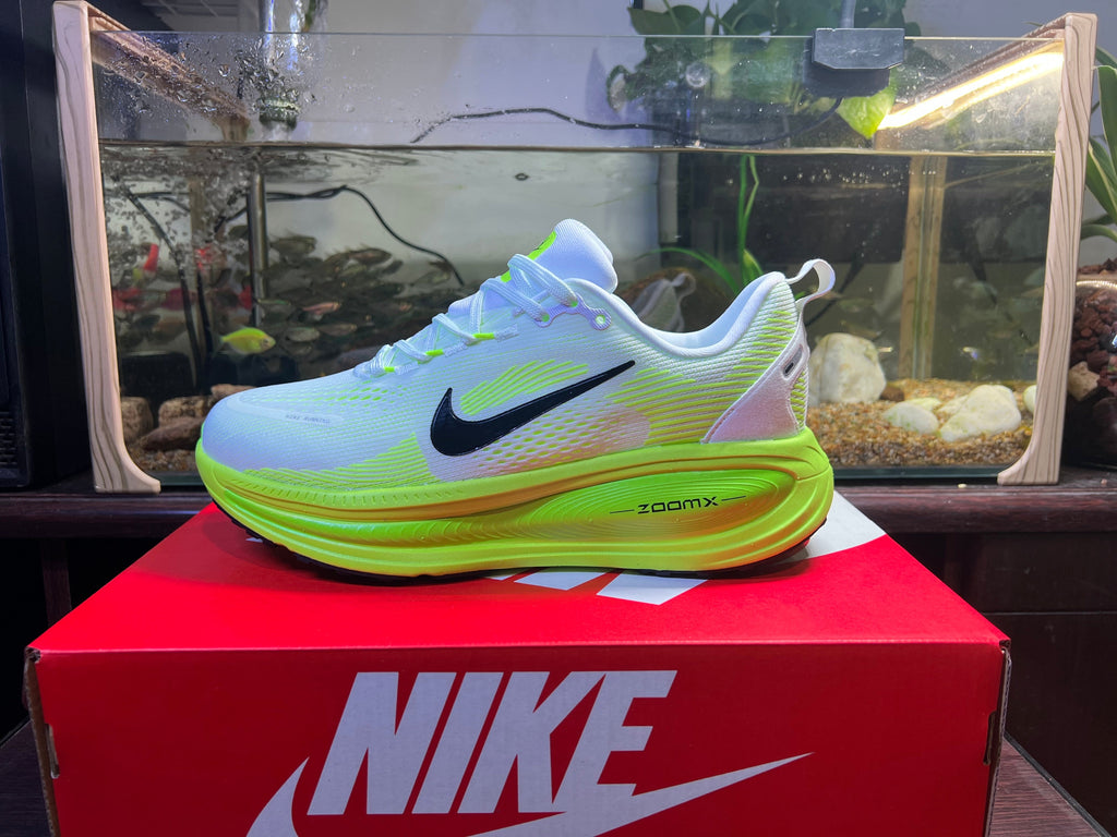 Blue and Volt Green Nike Vomero 18 Running Shoes - product image from the listing.