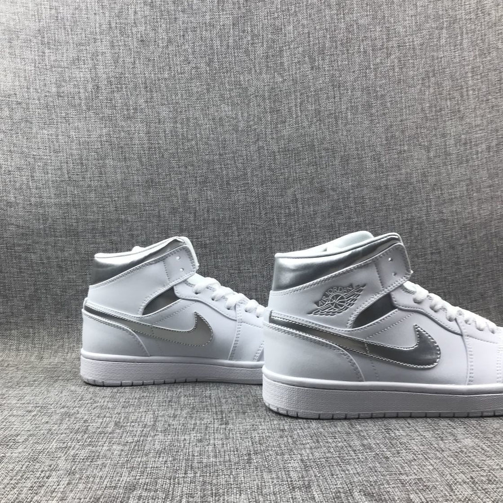 Air Jordan 1 Mid Sneakers in White Silver 554724-105 - product image from the listing.