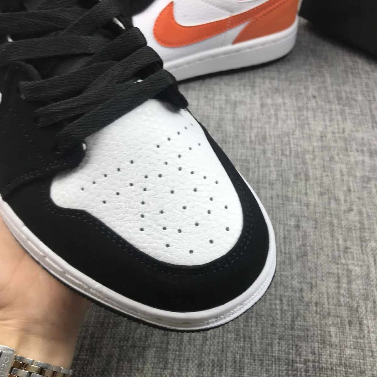 Air Jordan 1 Mid Sneakers in Black White Orange 554724-058 - product image from the listing.