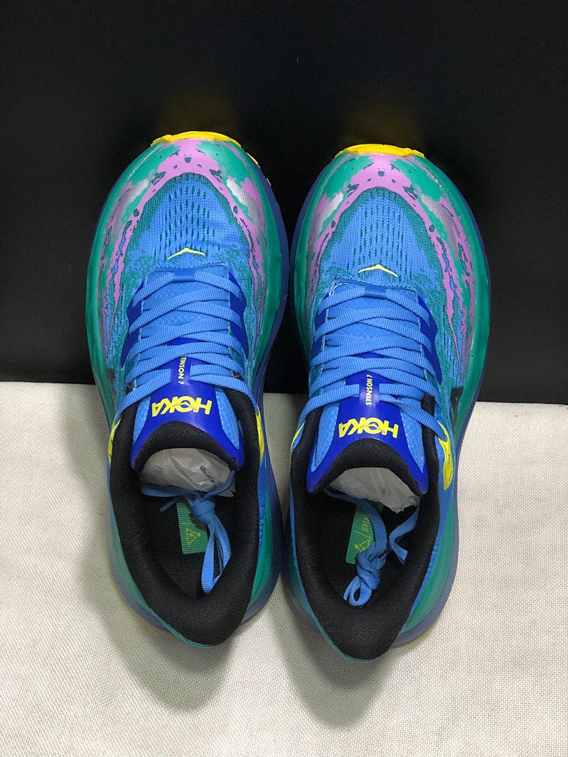 HOKA Stinson 7 Trail Sneakers in Blue Green Pink Yellow - product image from the listing.