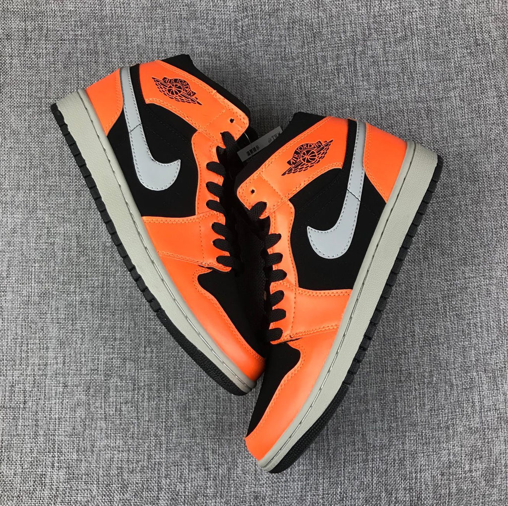 Air Jordan 1 Mid Sneakers in Black Orange 554724-062 - product image from the listing.