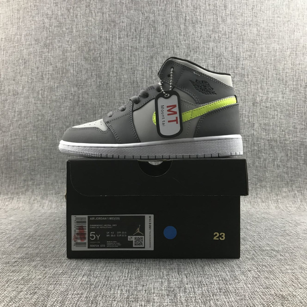 Air Jordan 1 Mid Sneakers in Grey Volt 554724-072 - product image from the listing.