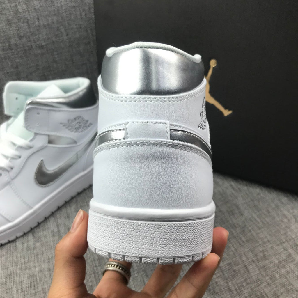 Air Jordan 1 Mid Sneakers in White Silver 554724-105 - product image from the listing.
