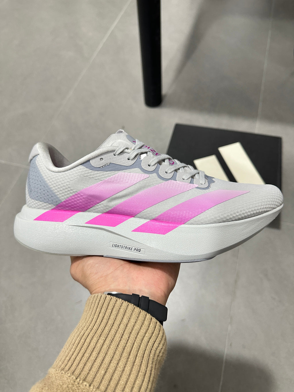adidas Adizero Lightstrike Pro Running Shoes, in Gray and Pink - product image from the listing.
