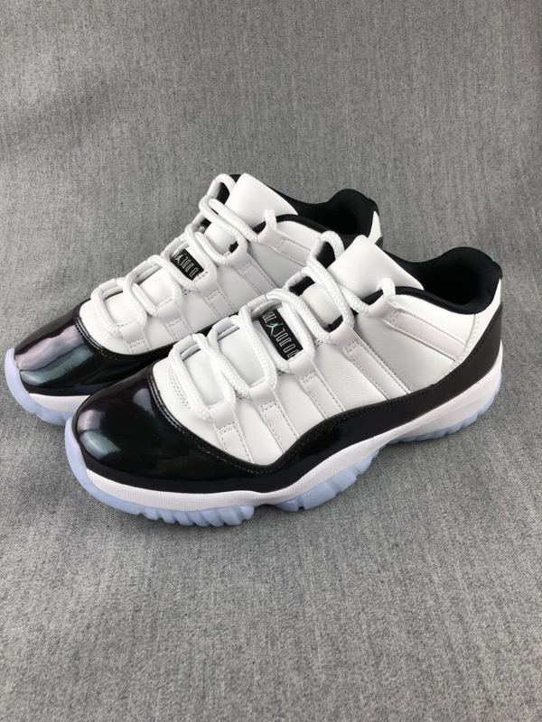White and Black Jordan 11 Low Sneakers - product image from the listing.