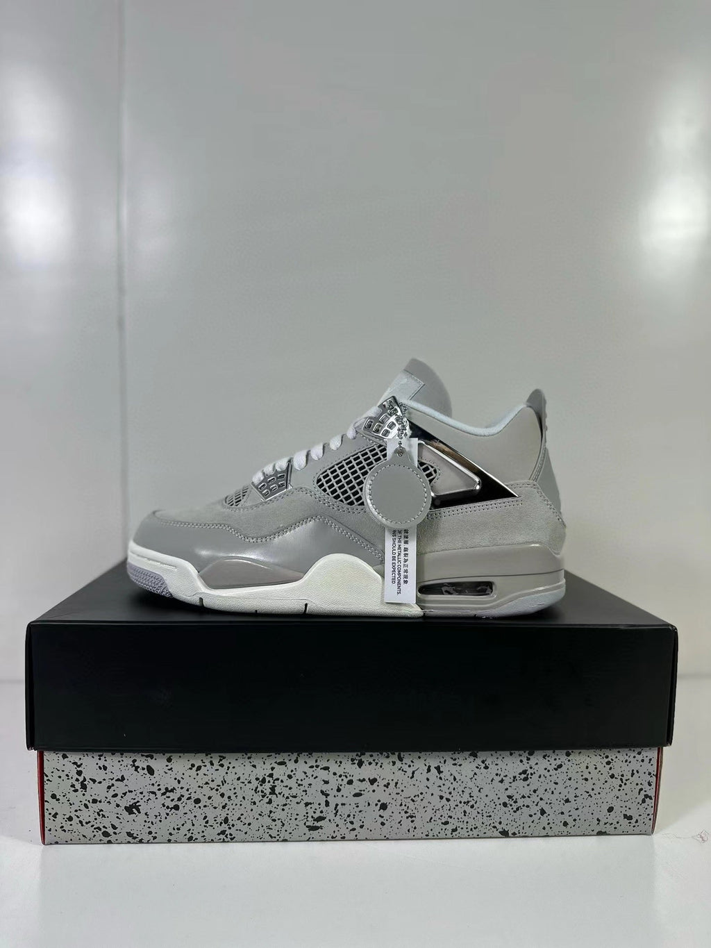 Air Jordan 4 Light Iron Ore Frozen Moments Sneakers - product image from the listing.