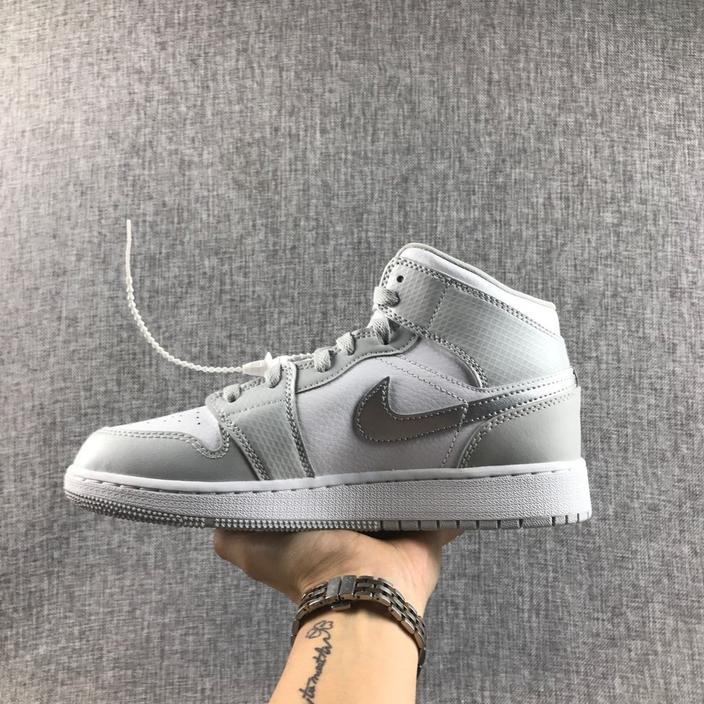 Air Jordan 1 Mid GS White and Silver Sneakers - product image from the listing.