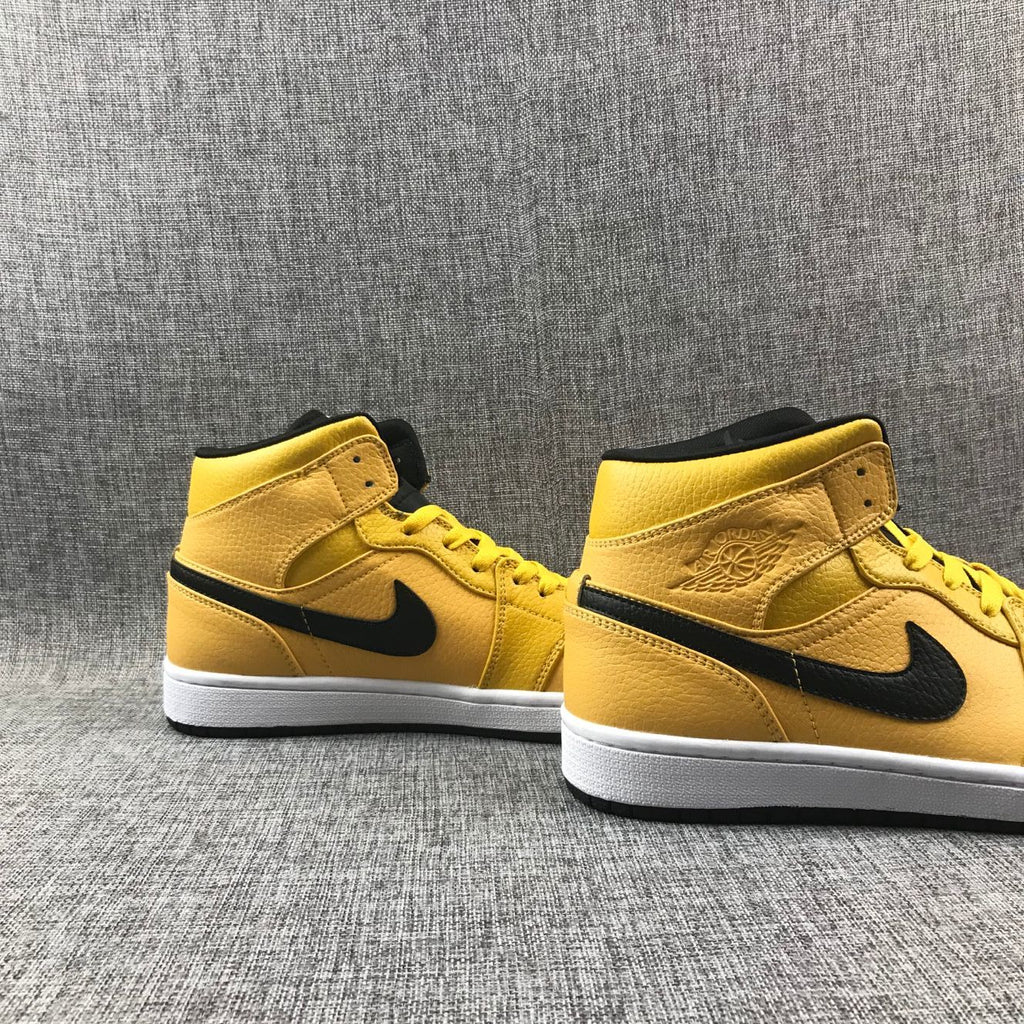 Air Jordan 1 Mid Yellow Ochre Sneakers in Black 554724-700 - product image from the listing.