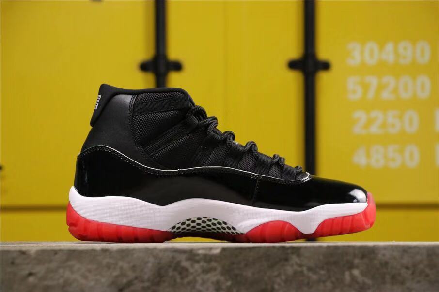 Air Jordan 11 Retro Bred High-Top Sneakers in Black and Red - product image from the listing.