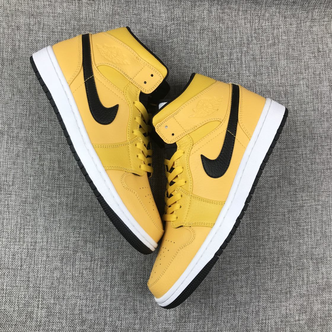 Air Jordan 1 Mid Yellow Ochre Sneakers in Black 554724-700 - product image from the listing.