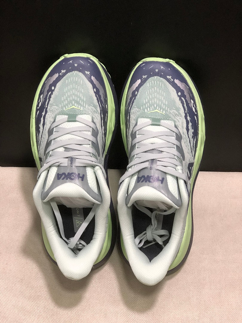 HOKA Stinson 7 Trail Running Shoes, in Green and Navy - product image from the listing.