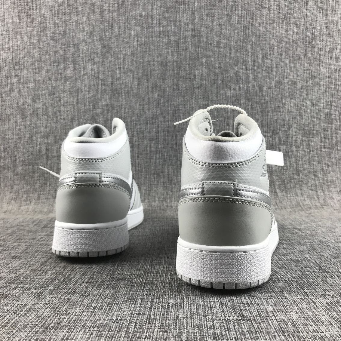 Air Jordan 1 Mid GS White and Silver Sneakers - product image from the listing.