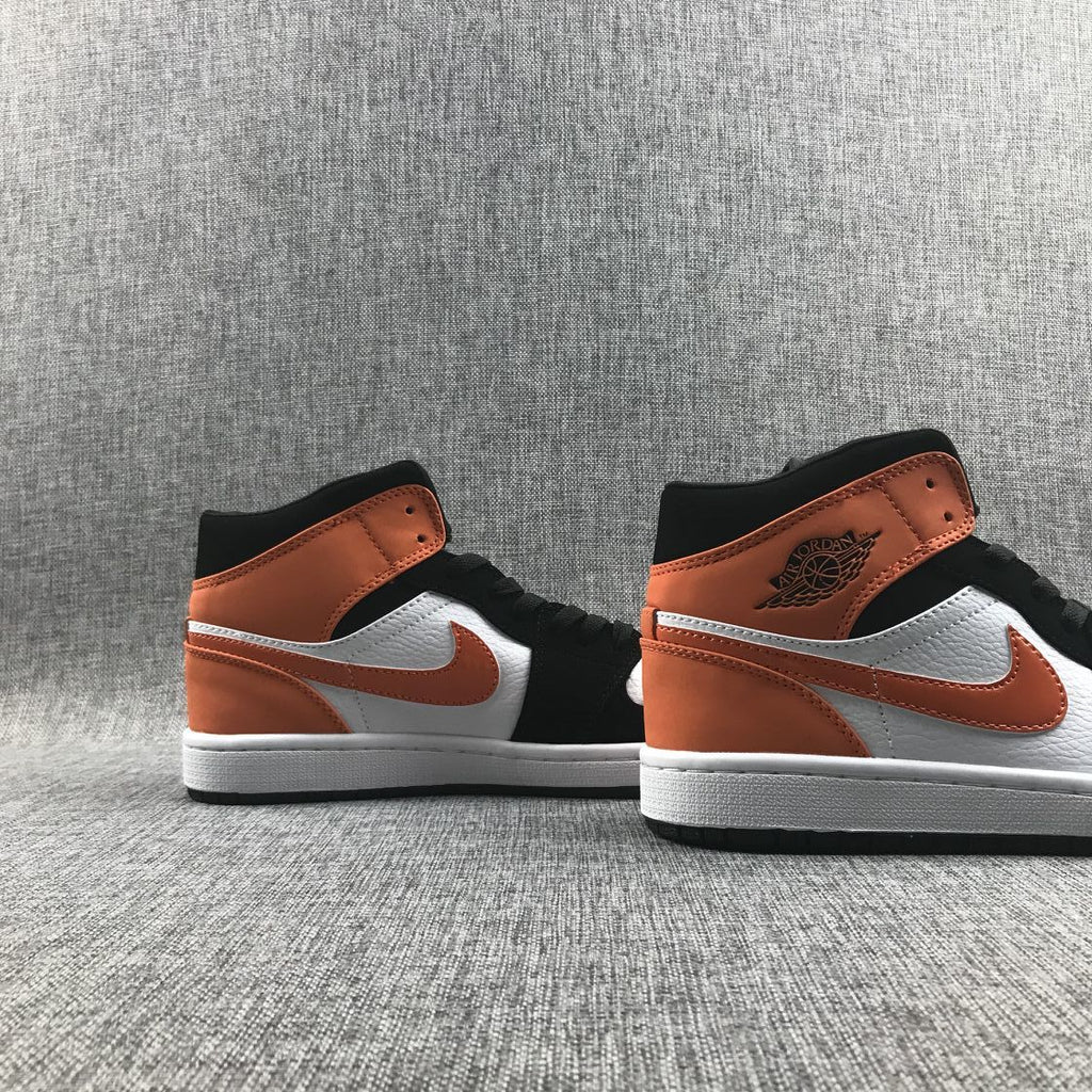Air Jordan 1 Mid Sneakers in Black White Orange 554724-058 - product image from the listing.