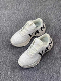 White Chunky Low-Cut Sneakers with Black Side Graphics - product image from the listing.