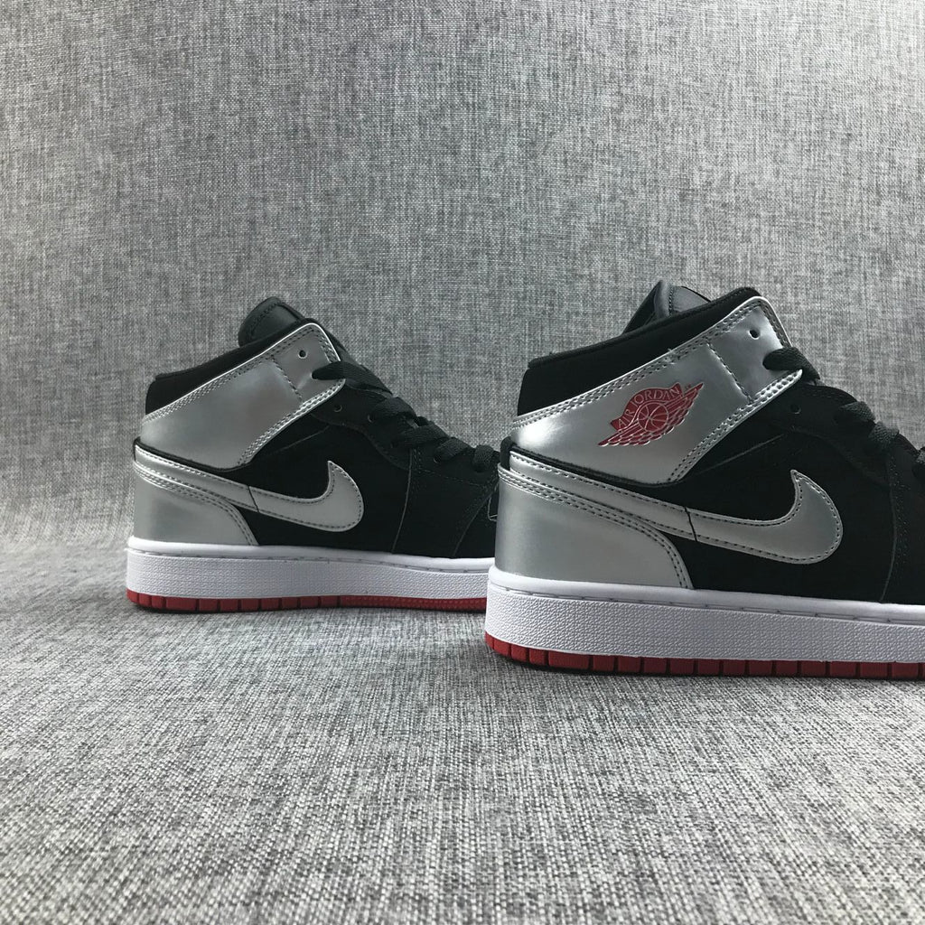 Air Jordan 1 Mid SE GS Sneakers in Black Silver 554725-057 - product image from the listing.