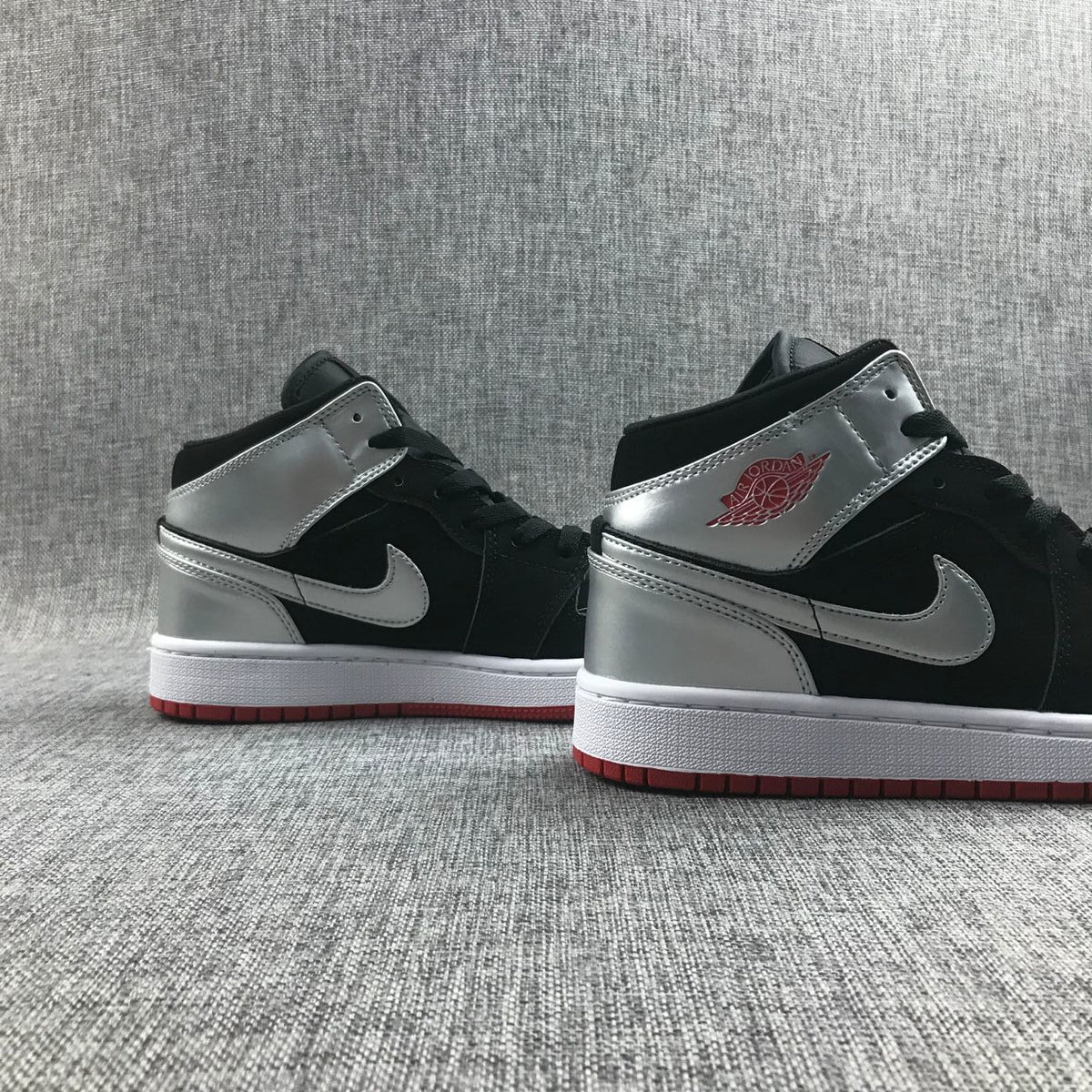 Air Jordan 1 Mid SE GS Sneakers in Black Silver 554725-057 - product image from the listing.