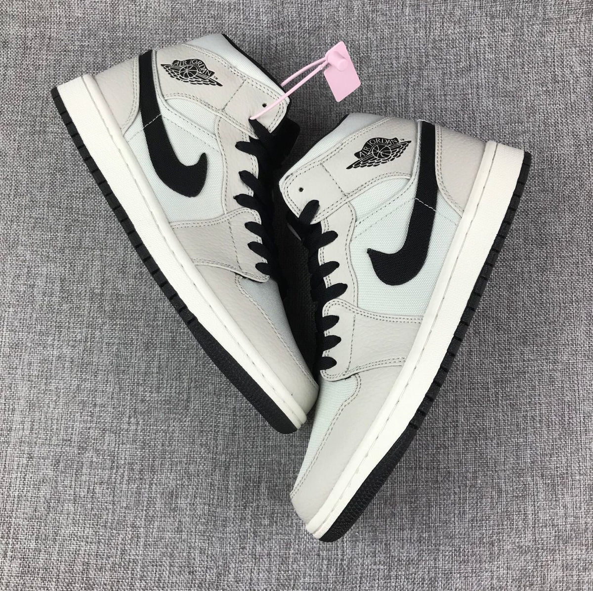 Air Jordan 1 Mid High-Top Sneakers in Grey and Black - product image from the listing.