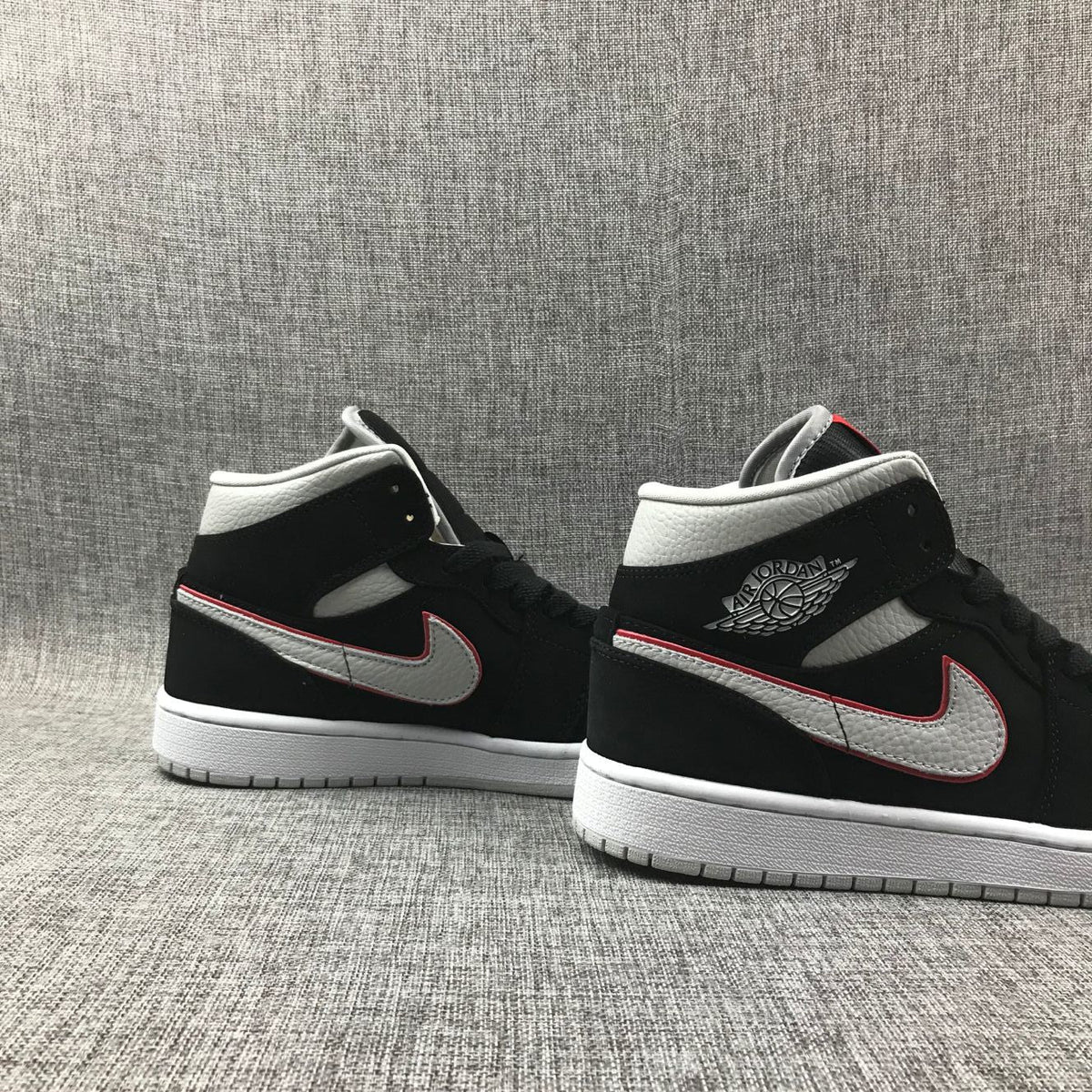 Air Jordan 1 Mid Black, Sneakers in White & Red 554724-060 - product image from the listing.