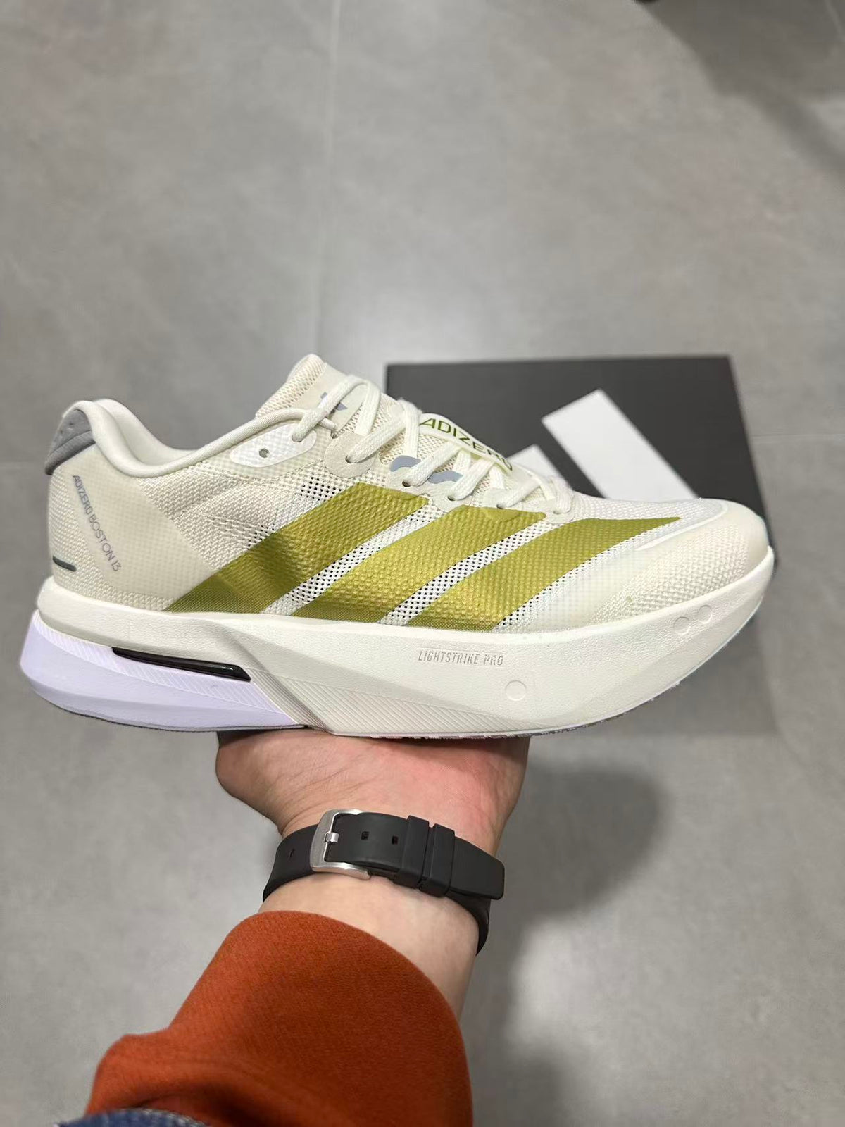 Adizero Lightstrike Pro Running Shoes in White and Olive JS4947 - product image from the listing.