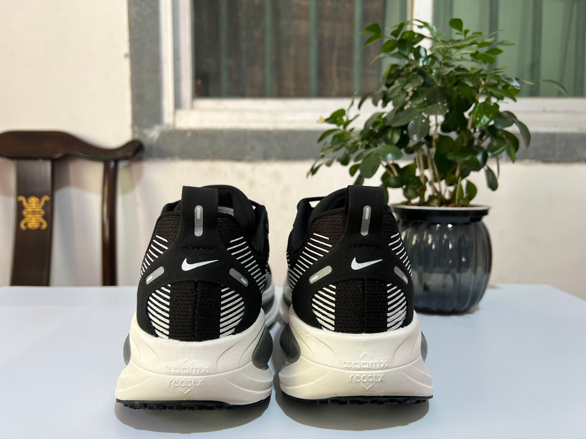 Nike Vomero 18 Running Shoes in Black and White - product image from the listing.