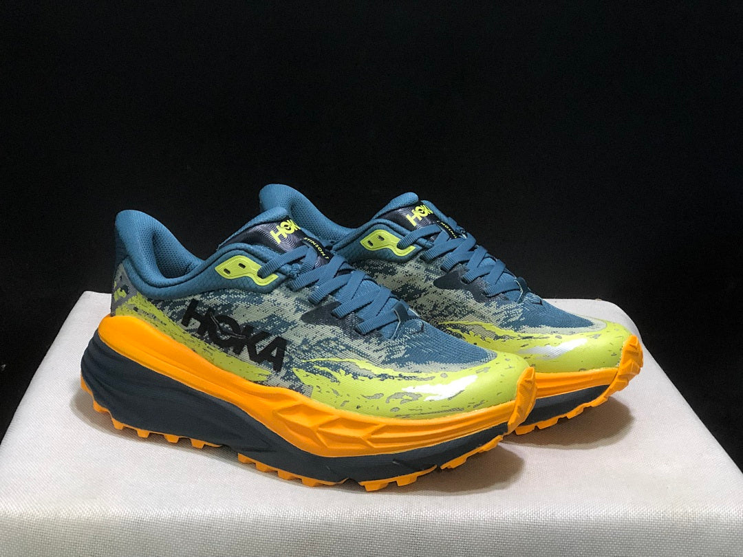 HOKA Stinson 7 Trail Running Shoes in Blue Yellow Orange - product image from the listing.