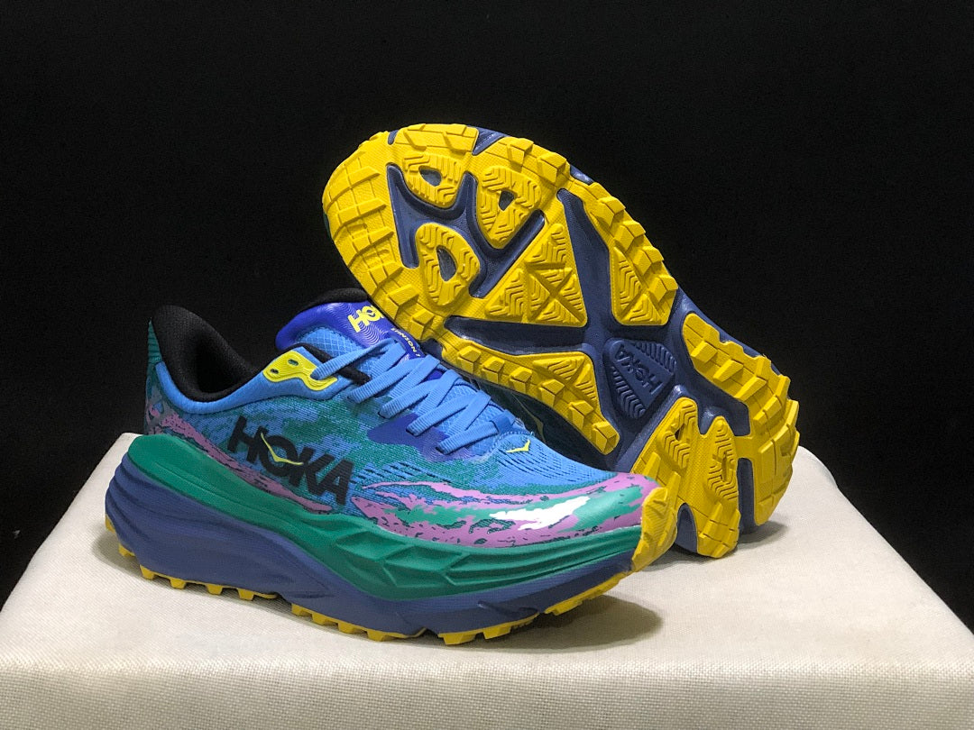 HOKA Stinson 7 Trail Sneakers in Blue Green Pink Yellow - product image from the listing.