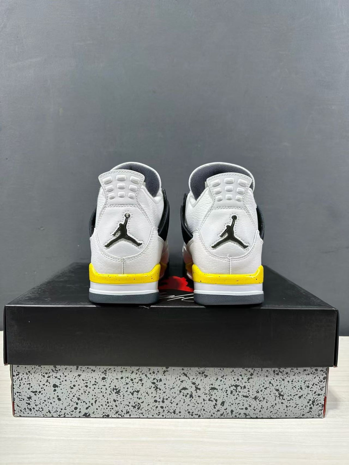 Air Jordan 4 Retro White Yellow Black Sneakers IO2468-102 - product image from the listing.